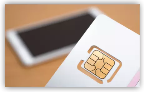 SIM card in front of smartphone on a table